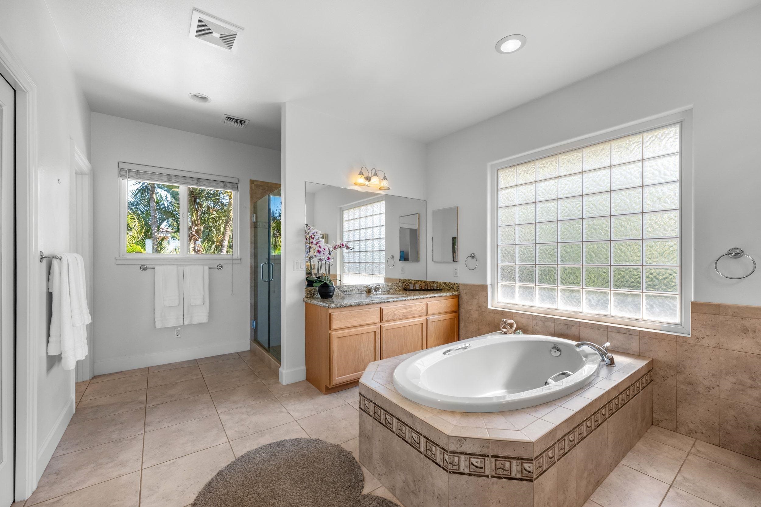 125 Kahana Makai Road Lahaina, HI 96761 - Photo 22 of 46 a spacious bathroom with a bathtub a sink and a window