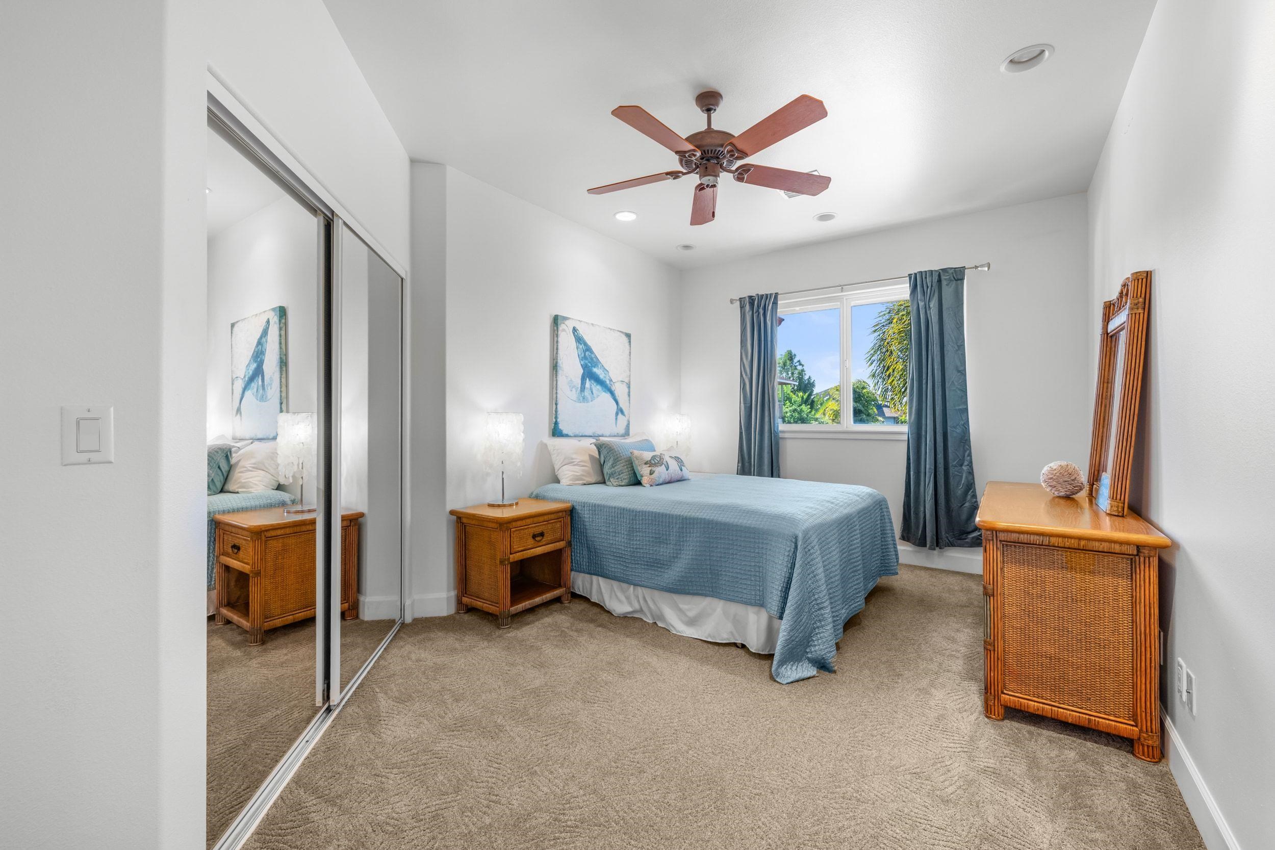125 Kahana Makai Road Lahaina, HI 96761 - Photo 26 of 46 a bedroom with a bed and a chandelier