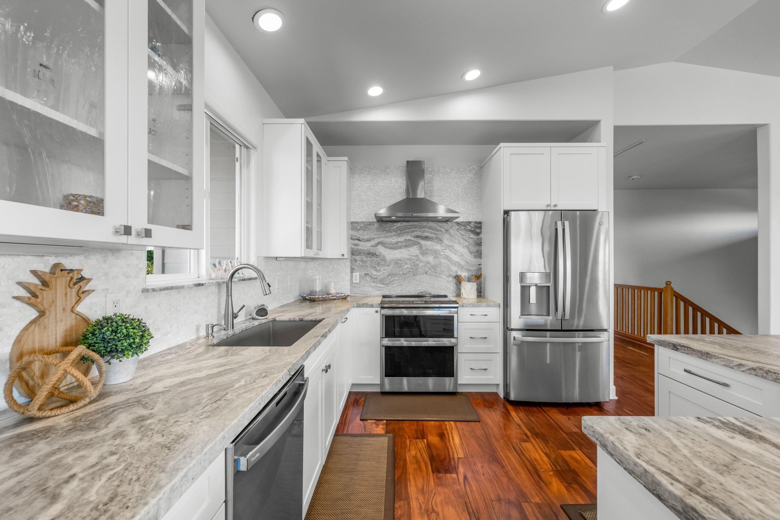125 Kahana Makai Road Lahaina, HI 96761 - Photo 5 of 46 a kitchen with kitchen island granite countertop a sink stove and refrigerator