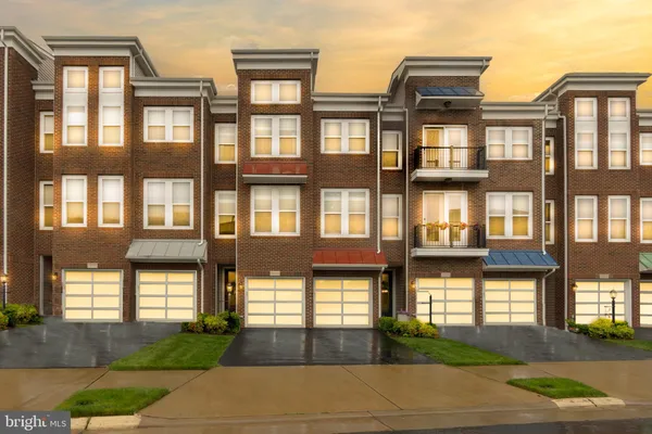 a front view of a residential apartment building with a yard