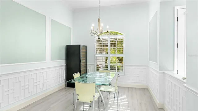 a dining room with furniture window and wooden floor