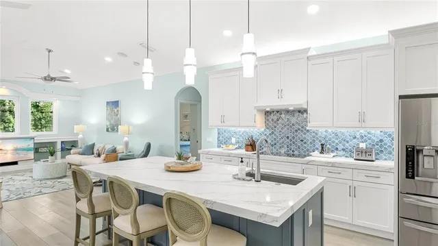 a kitchen with a table chairs and white cabinets