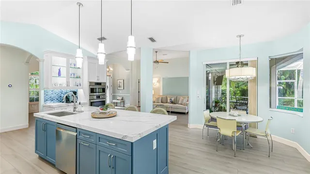 a kitchen with a table chairs and wooden floor