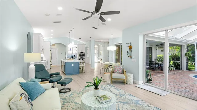 a living room with furniture kitchen and a chandelier