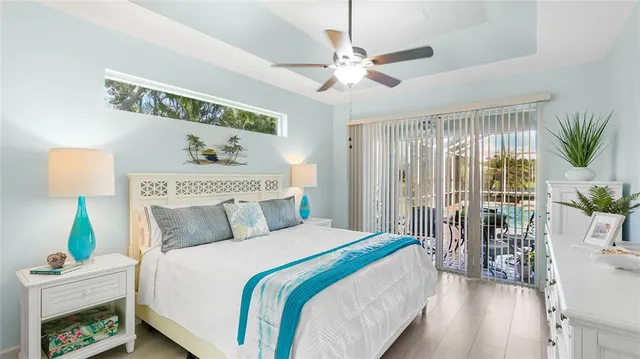 a bedroom with a large bed and a chandelier