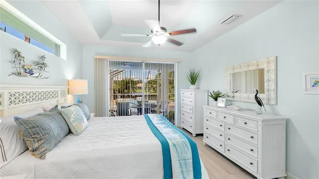 a bedroom with a large bed and a chandelier