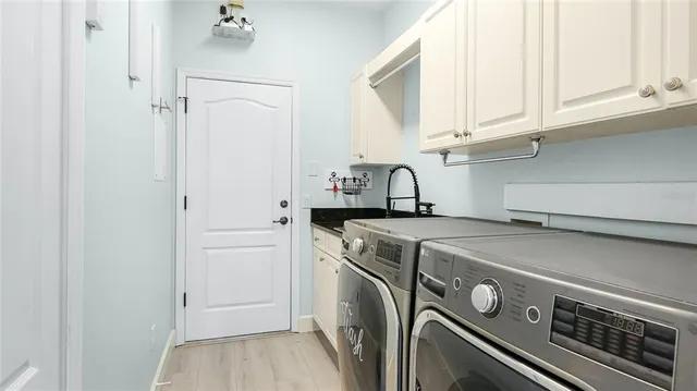 a view of a storage and utility room with washer and dryer