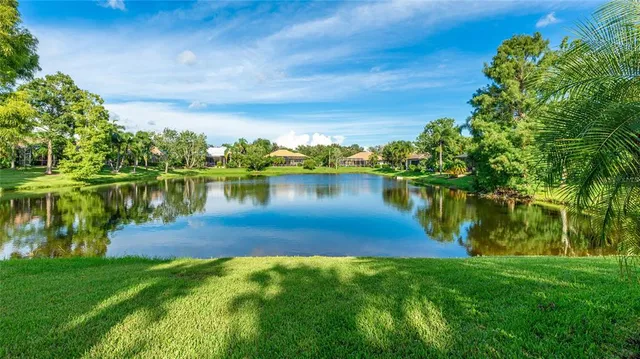 a view of a lake with houses in the back