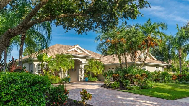 a view of a palm trees front of house