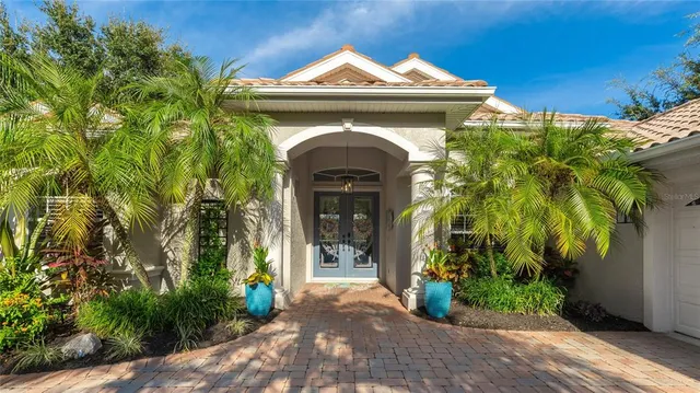 a view of a house with potted plants