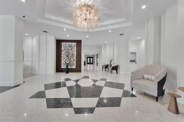 a living room with furniture and a chandelier