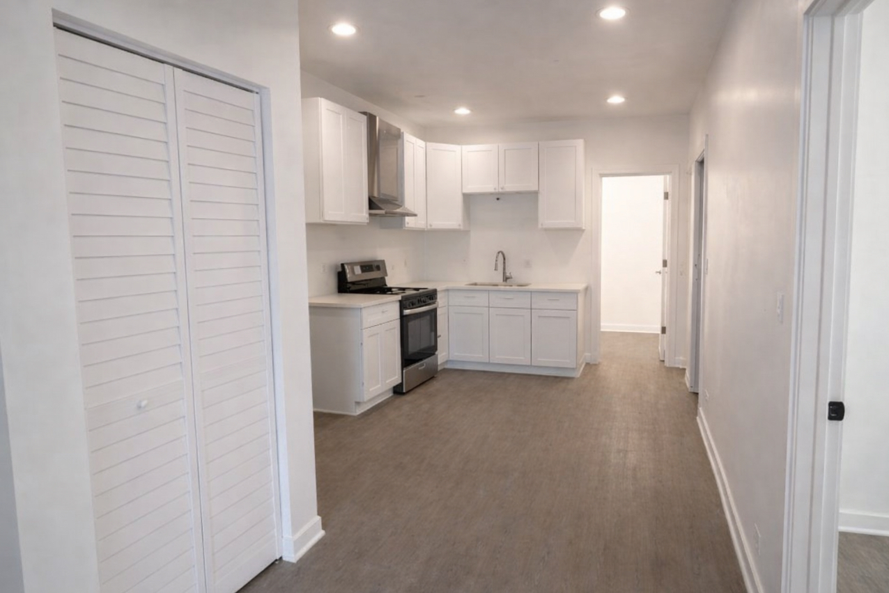 4519 West Thomas Street, Unit 1 Chicago, IL 60651 - Photo 3 of 6 a kitchen with white cabinets and white appliances