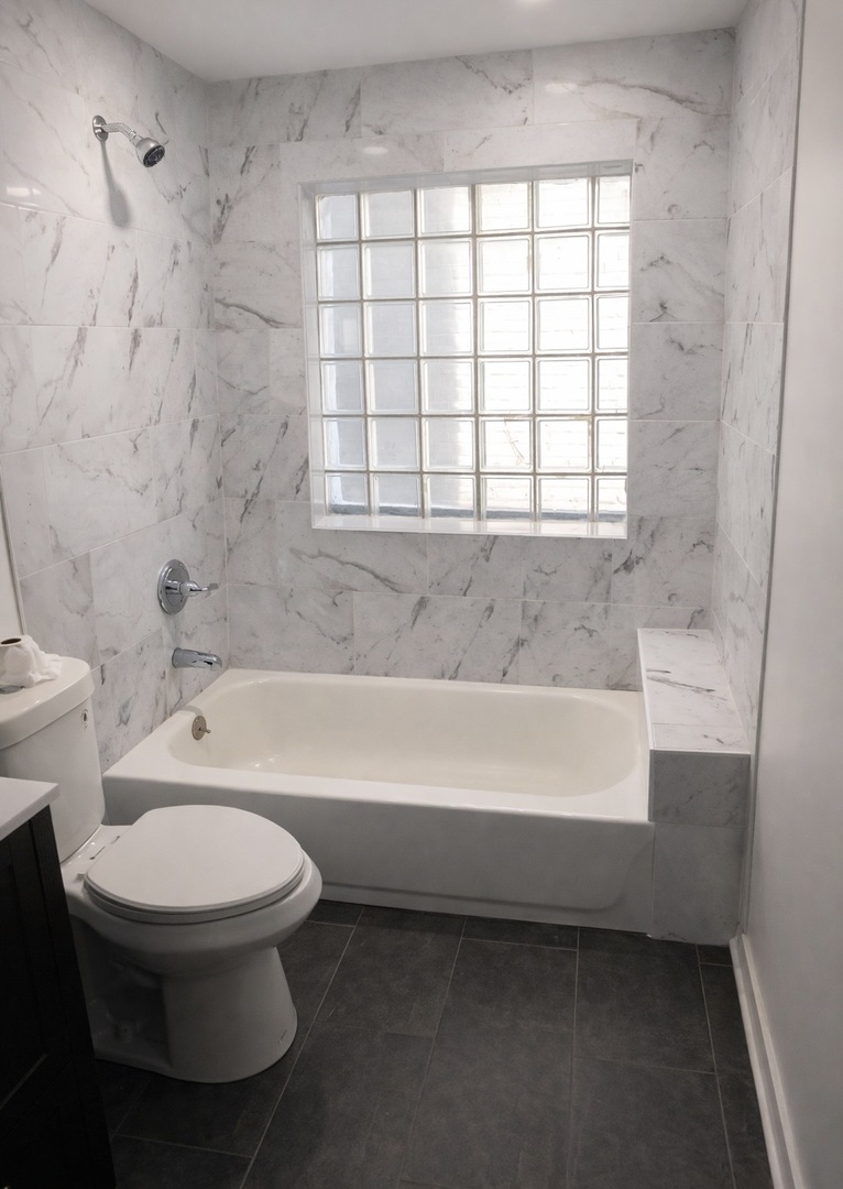4519 West Thomas Street, Unit 1 Chicago, IL 60651 - Photo 6 of 6 a bathroom with a toilet a sink and bathtub