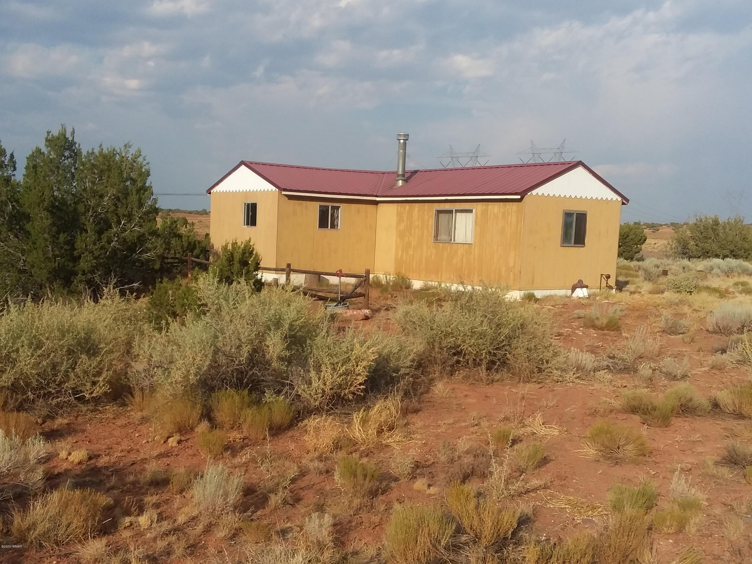 Lot 361 Woodridge Ranch, Unit 9 Concho, AZ 85924 - Photo 2 of 22 a front view of a house with a yard
