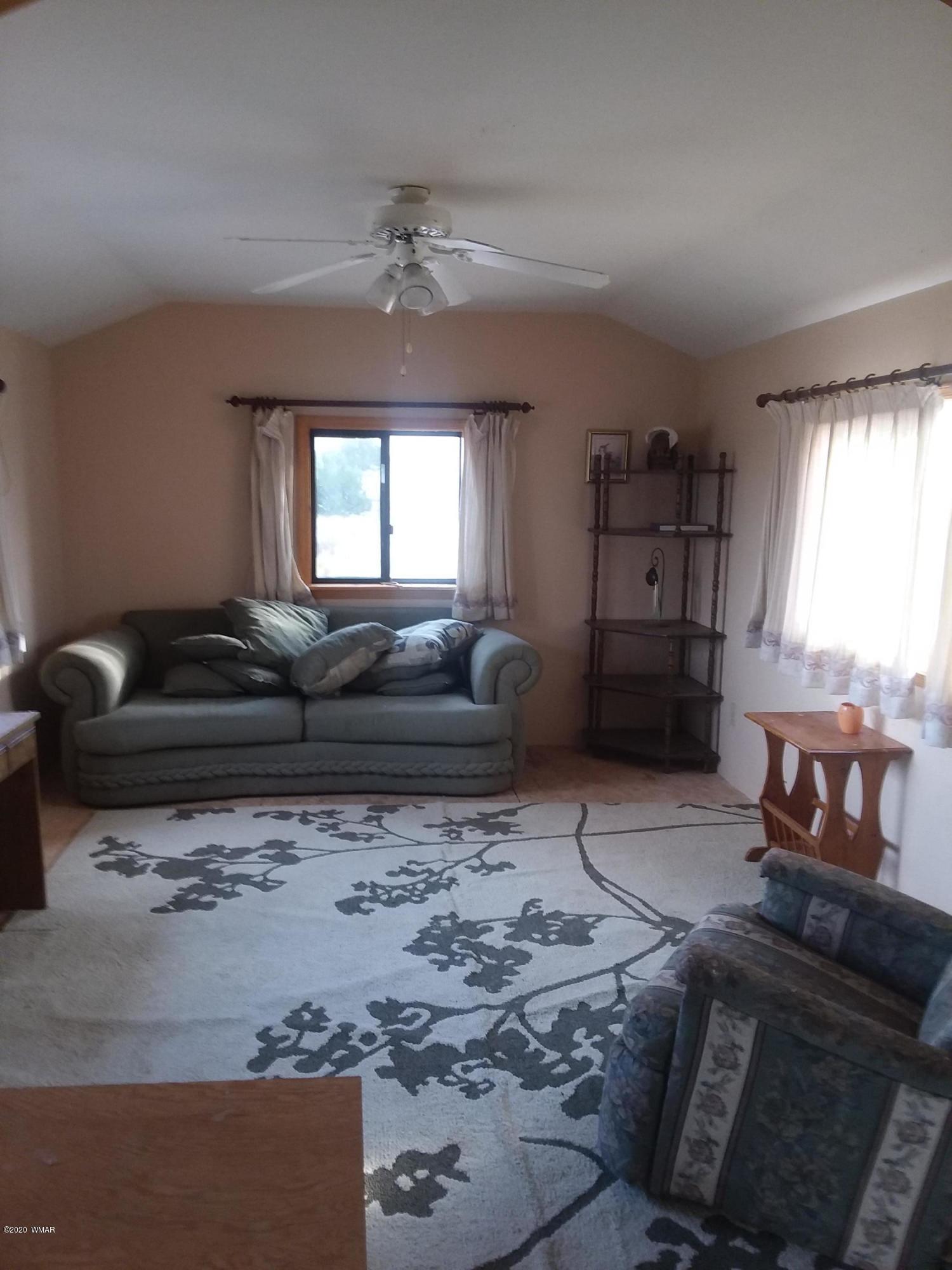 Lot 361 Woodridge Ranch, Unit 9 Concho, AZ 85924 - Photo 5 of 22 a living room with furniture and a fireplace