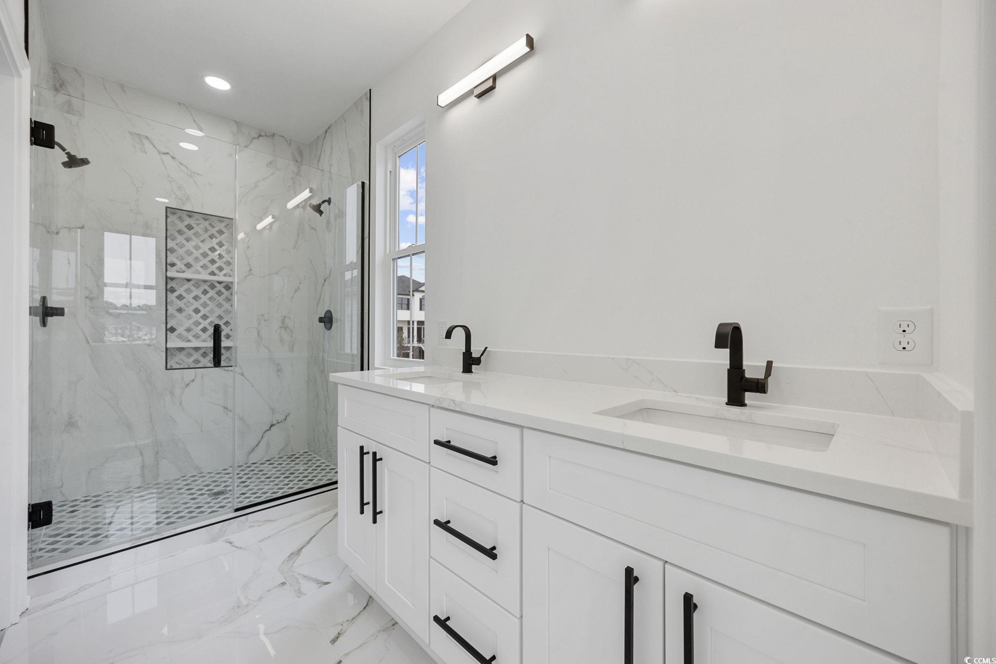 514 Harbour View Drive Myrtle Beach, SC 29579 - Photo 17 of 40 Full bathroom featuring double vanity, light marble finish floors, a marble finish shower, and recessed lighting