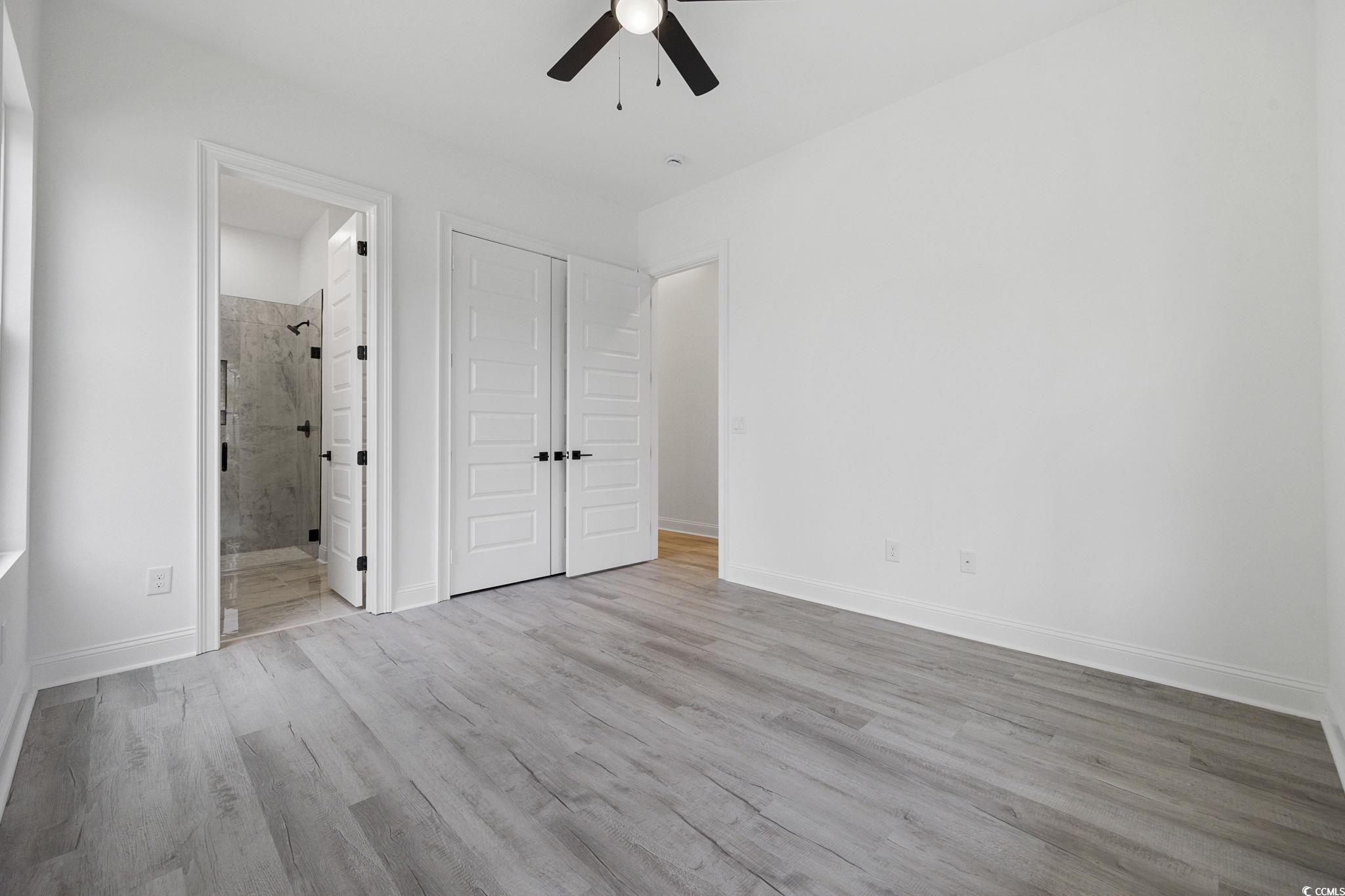 514 Harbour View Drive Myrtle Beach, SC 29579 - Photo 22 of 40 Unfurnished bedroom featuring light wood finished floors, ceiling fan, a closet, and ensuite bathroom