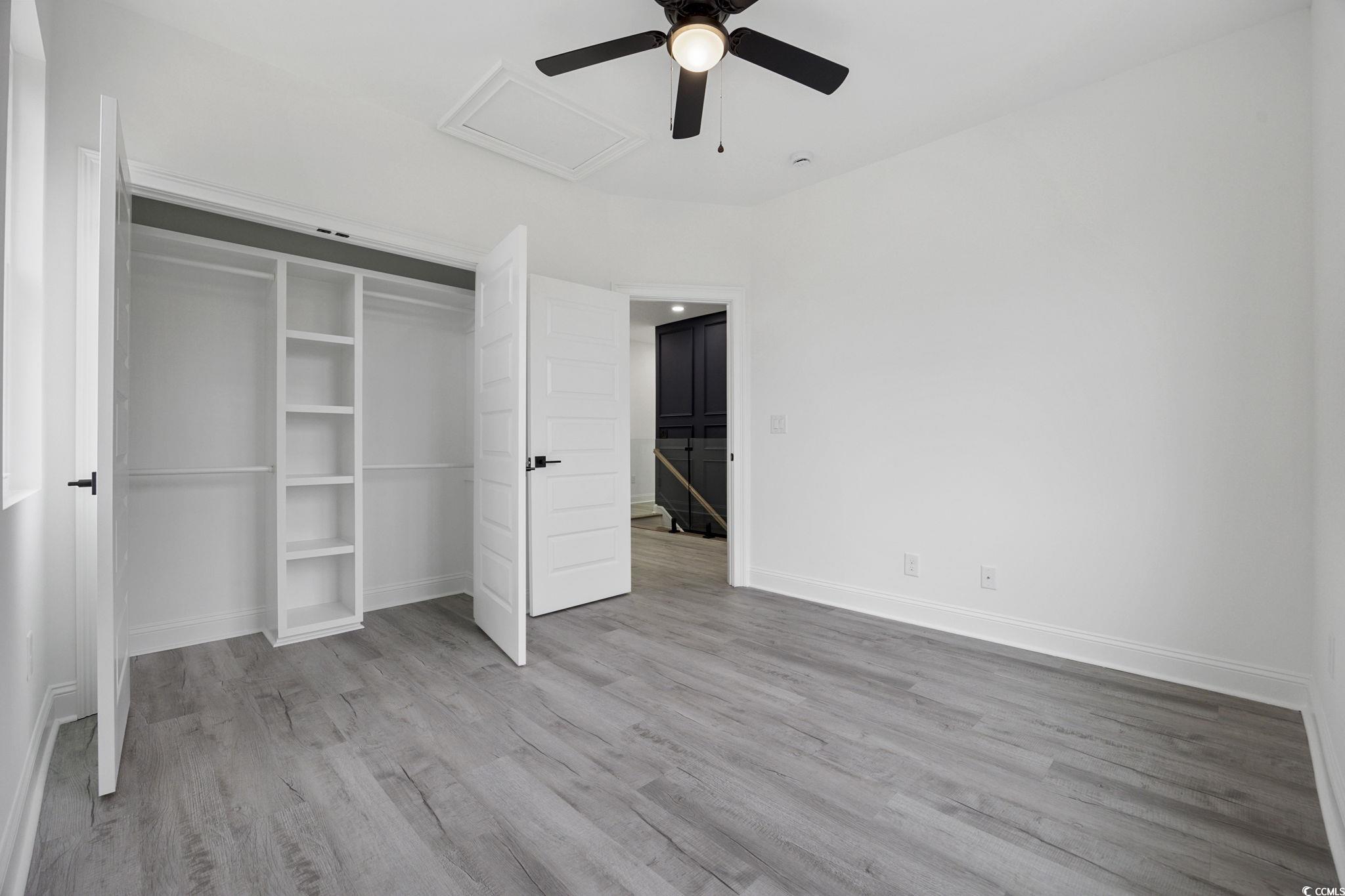 514 Harbour View Drive Myrtle Beach, SC 29579 - Photo 32 of 40 Unfurnished bedroom featuring light wood-style flooring, a ceiling fan, a closet, and attic access