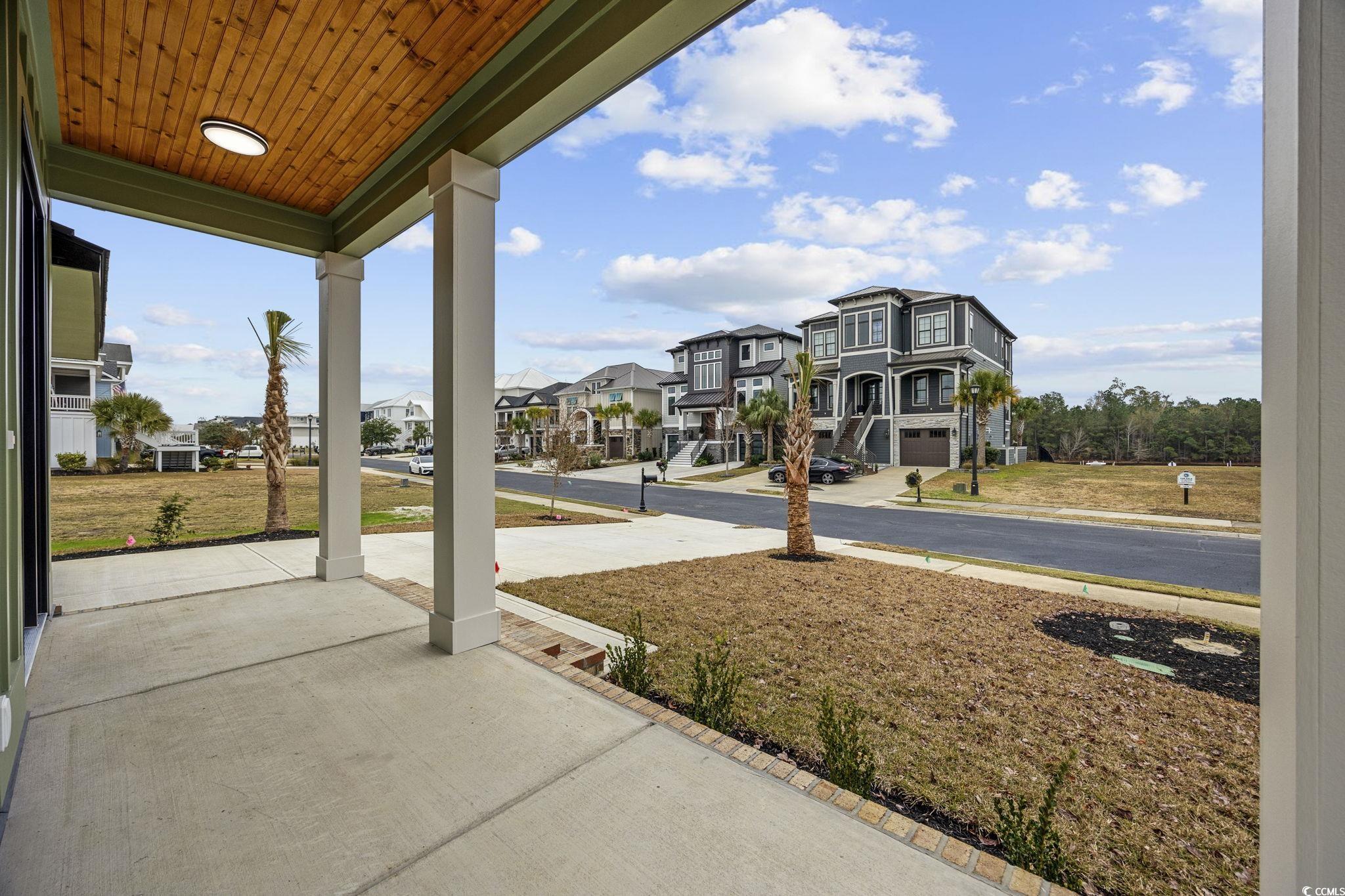 514 Harbour View Drive Myrtle Beach, SC 29579 - Photo 35 of 40 Covered porch featuring a yard and a residential view