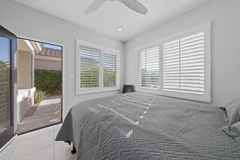 a large bed sitting in a bedroom next to a window