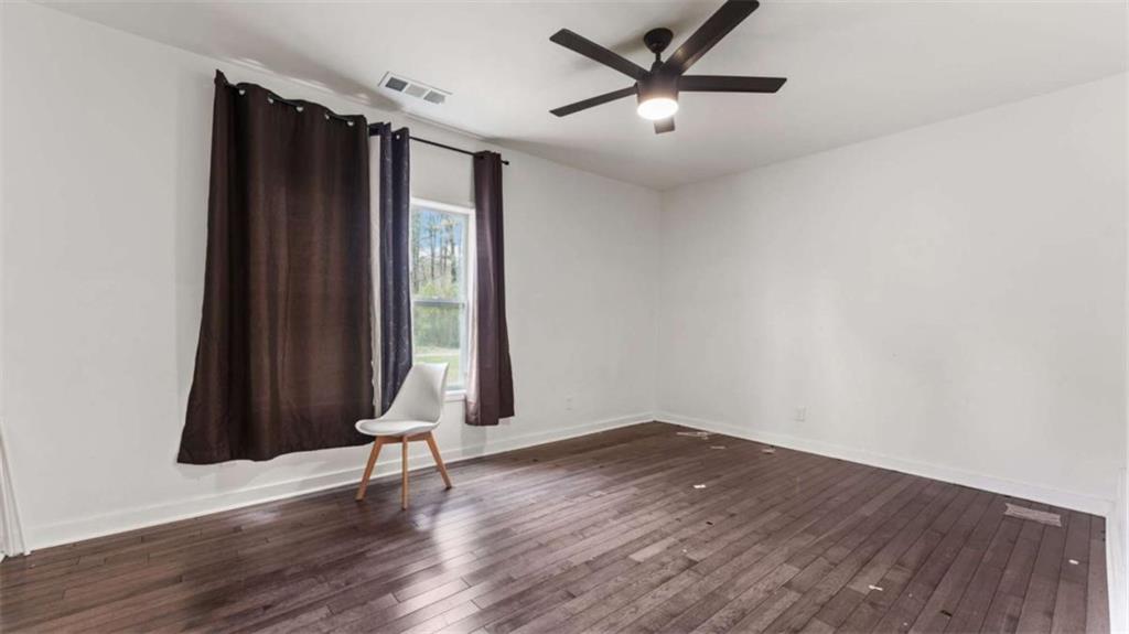 5491 Hill Road Southwest Powder Springs, GA 30127 - Photo 13 of 22 an empty room with wooden floor and windows