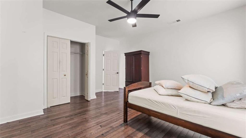 5491 Hill Road Southwest Powder Springs, GA 30127 - Photo 16 of 22 a bedroom with a bed and wooden floor