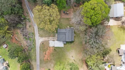 a bird view of house next to a yard