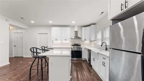 a kitchen with sink and refrigerator