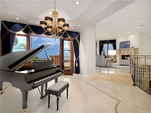 a kitchen with stainless steel appliances granite countertop dining table chairs sink and wooden cabinets
