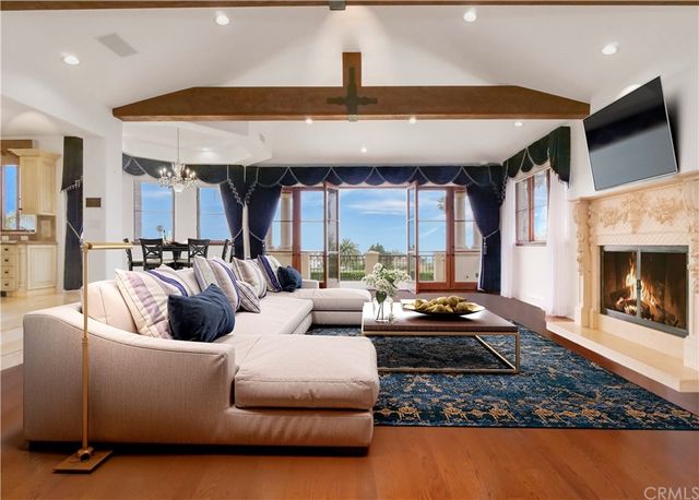 a kitchen with granite countertop a stove a sink a dining table and chairs