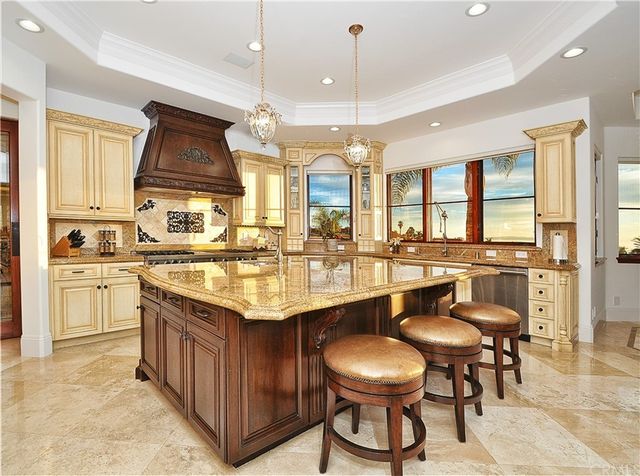 a spacious bathroom with a granite countertop tub a double vanity sink and a large mirror
