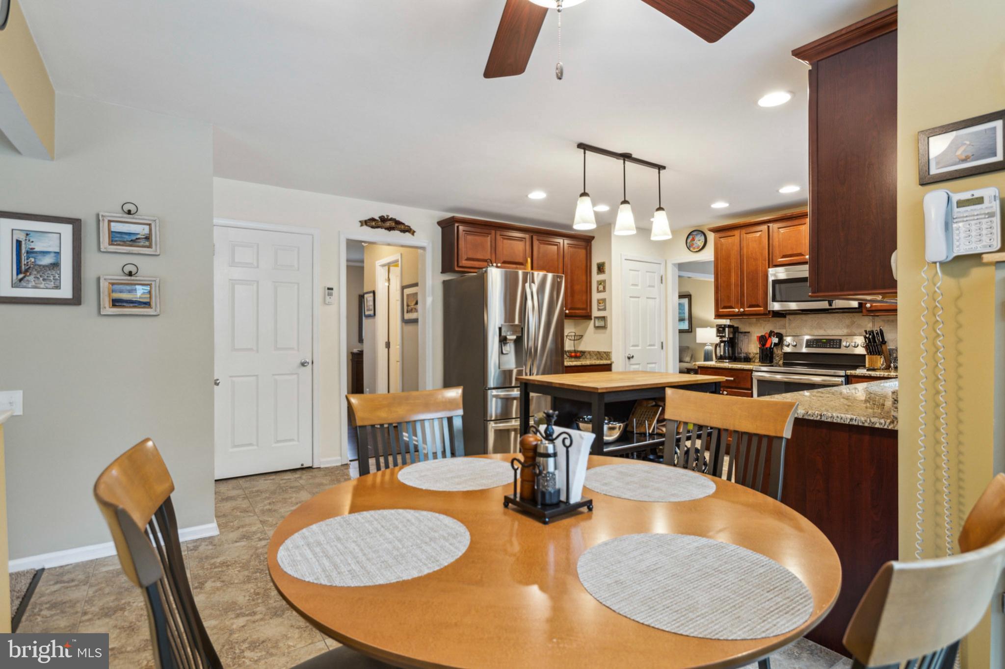24 Oakview Drive Newark, DE 19702 - Photo 13 of 39 a dining room with granite countertop a table chairs and kitchen view