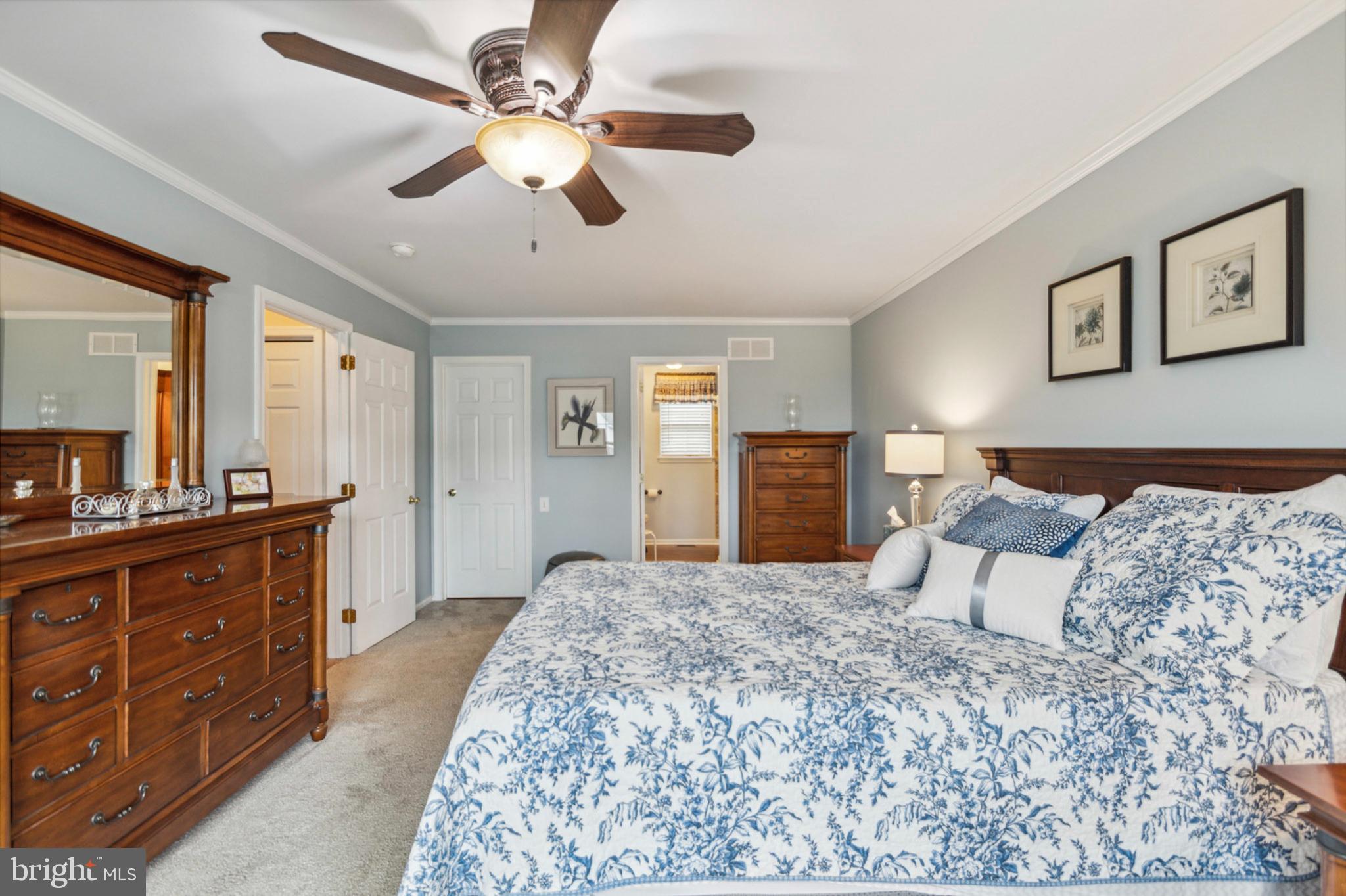 24 Oakview Drive Newark, DE 19702 - Photo 20 of 39 a bedroom with a large bed and a chandelier