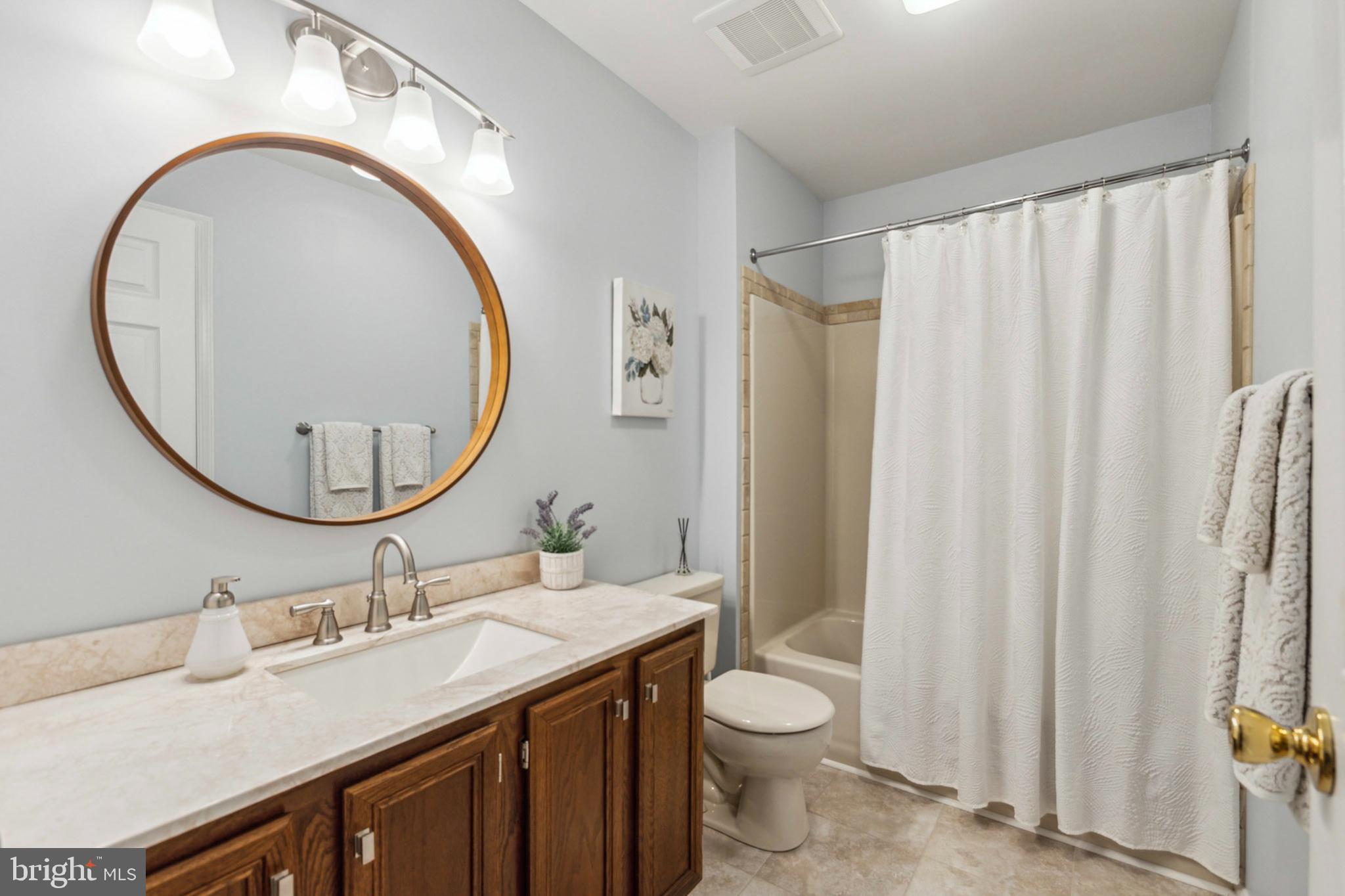 24 Oakview Drive Newark, DE 19702 - Photo 25 of 39 a bathroom with a sink a mirror a toilet and a mirror
