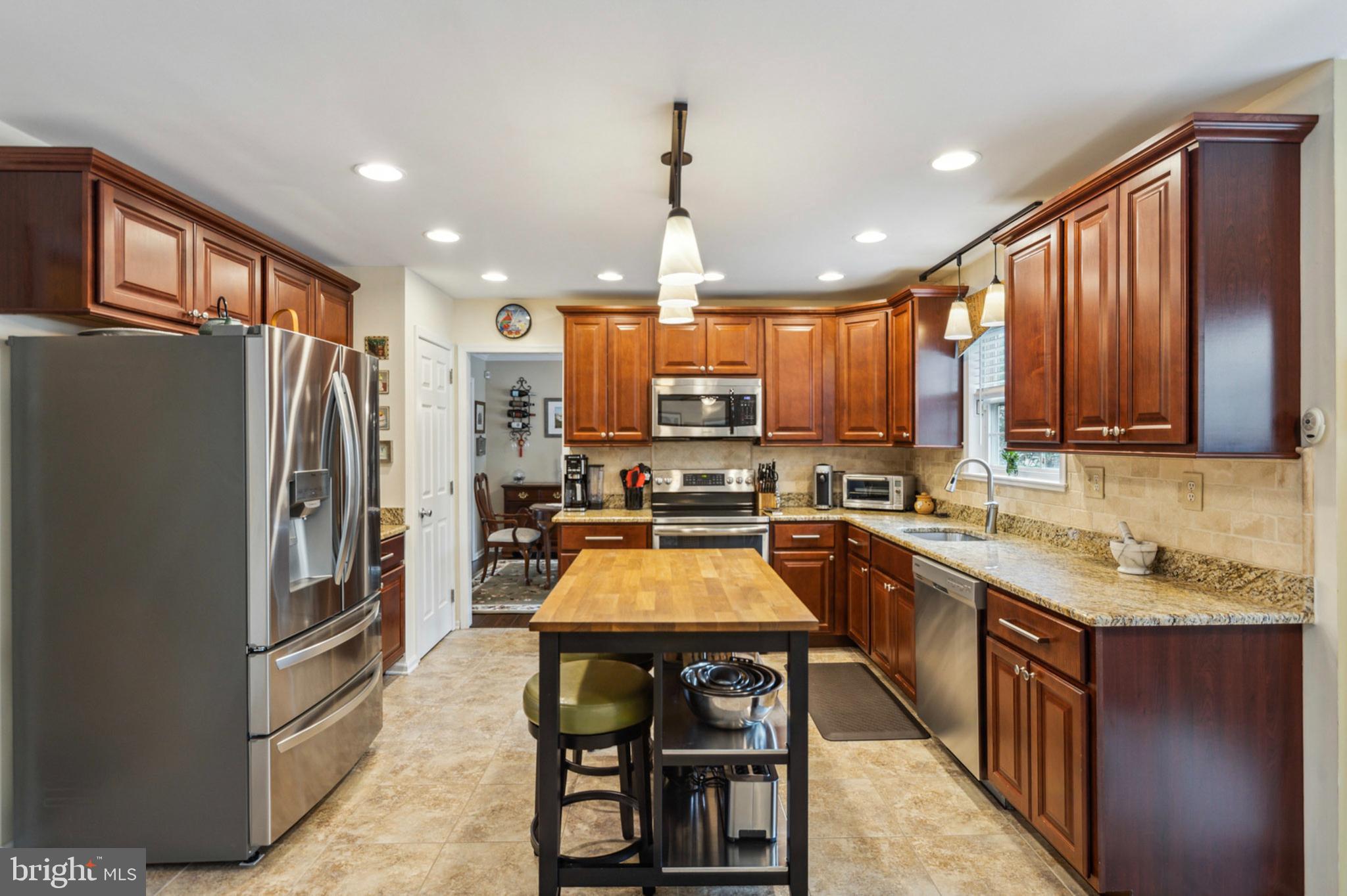24 Oakview Drive Newark, DE 19702 - Photo 10 of 39 a kitchen with granite countertop a center island stainless steel appliances and cabinets