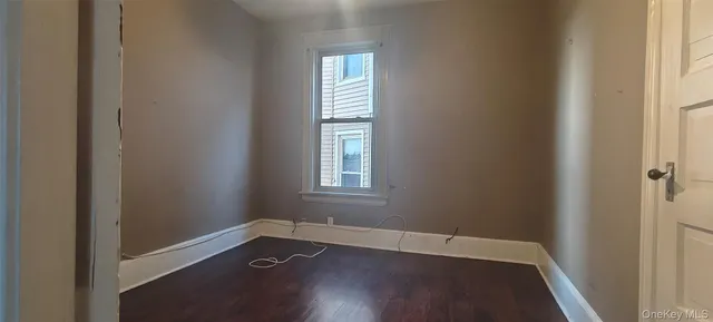 an empty room with windows and entrance