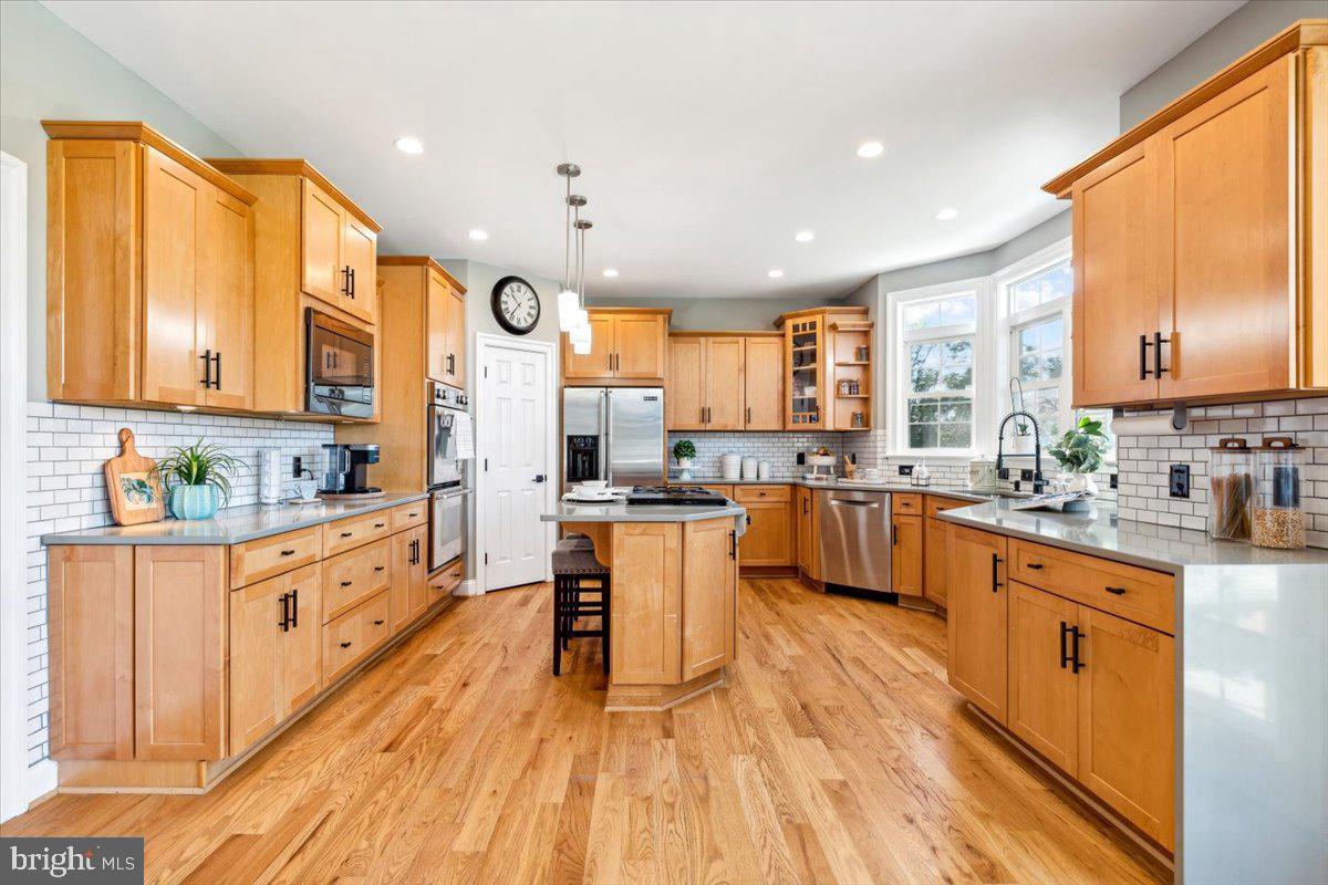 5340 Old Middletown Road Jefferson, MD 21755 - Photo 12 of 55 a kitchen with stainless steel appliances granite countertop wooden cabinets a sink dishwasher a stove and a refrigerator with wooden floor