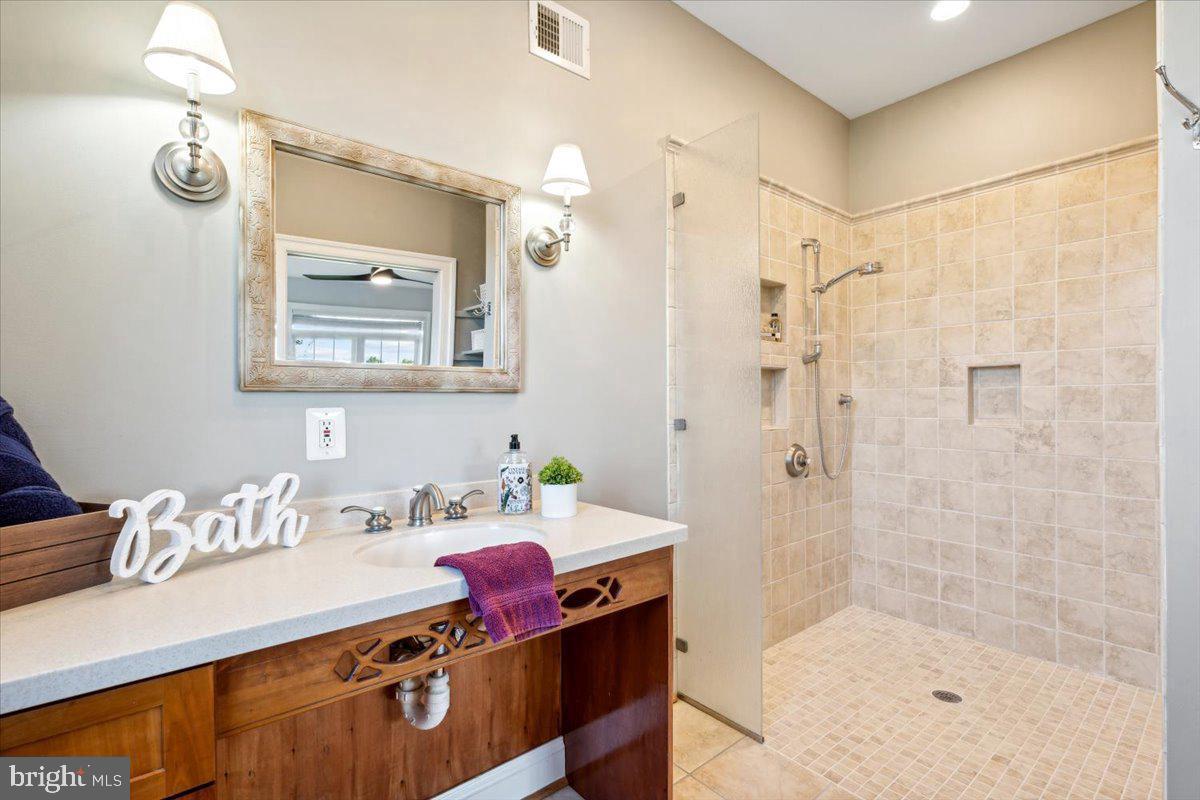 5340 Old Middletown Road Jefferson, MD 21755 - Photo 21 of 55 a bathroom with a sink mirror and a shower