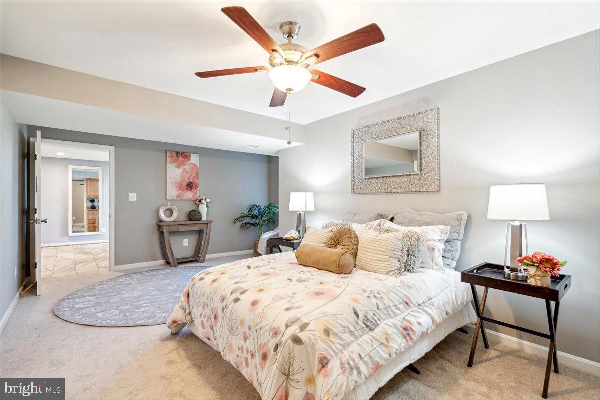 5340 Old Middletown Road Jefferson, MD 21755 - Photo 45 of 55 a spacious bedroom with a bed a couch and a chandelier