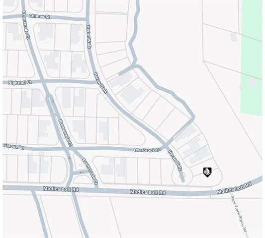 a street sign sitting on a wall next to a road