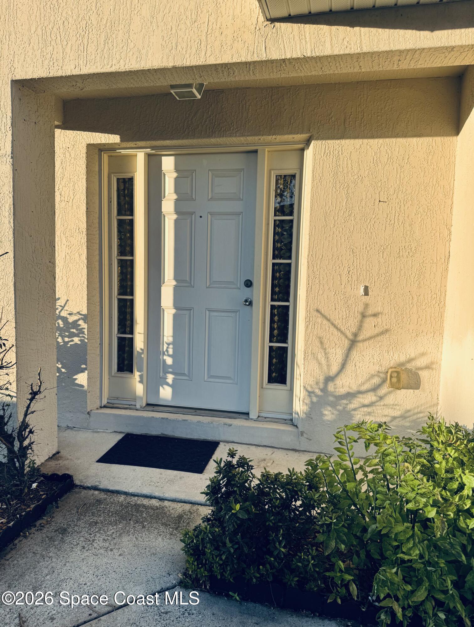 4550 Elena Way Melbourne, FL 32934 - Photo 2 of 33 a front view of a house with a yard