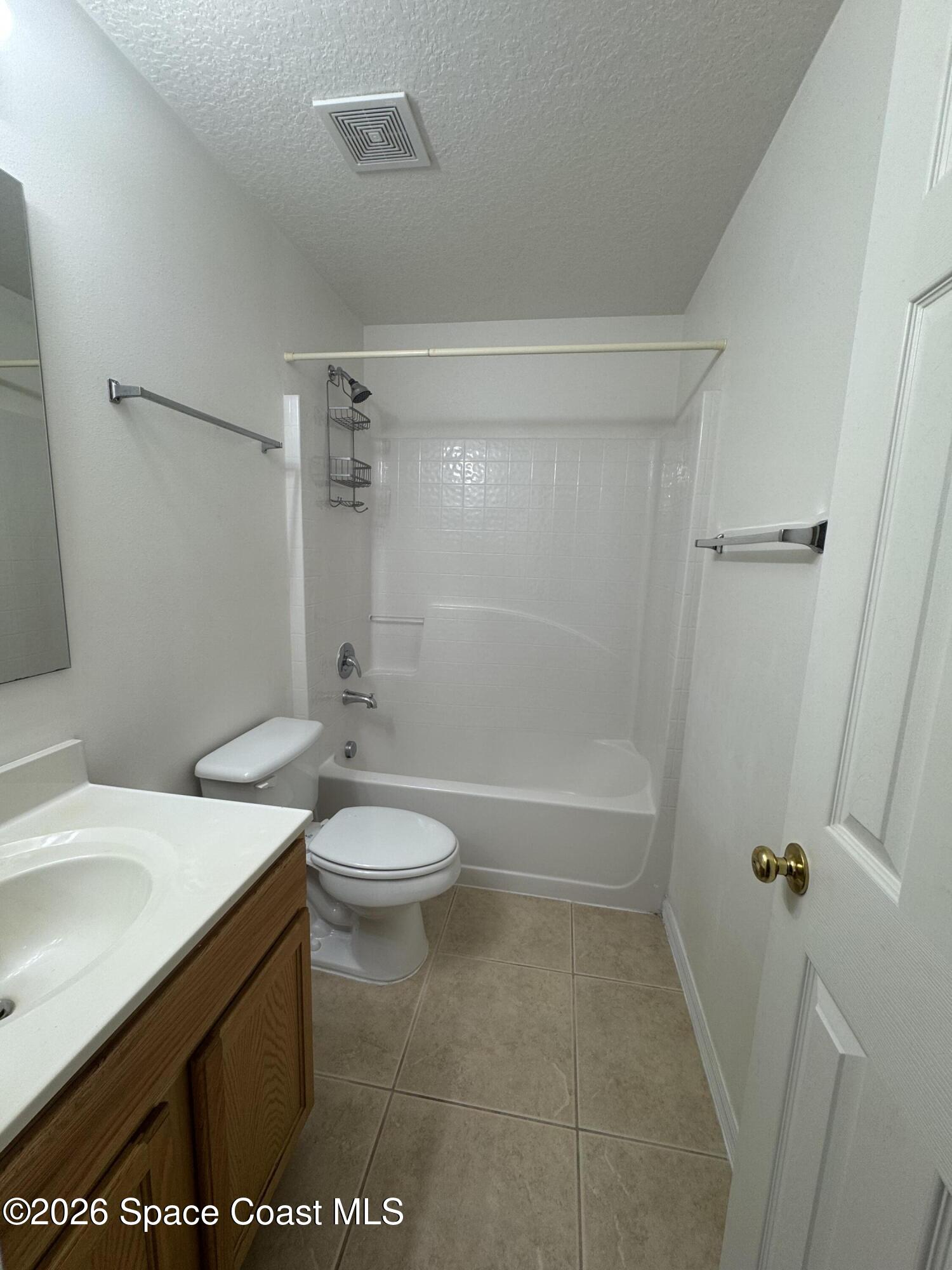 4550 Elena Way Melbourne, FL 32934 - Photo 22 of 33 a bathroom with a sink a toilet and shower