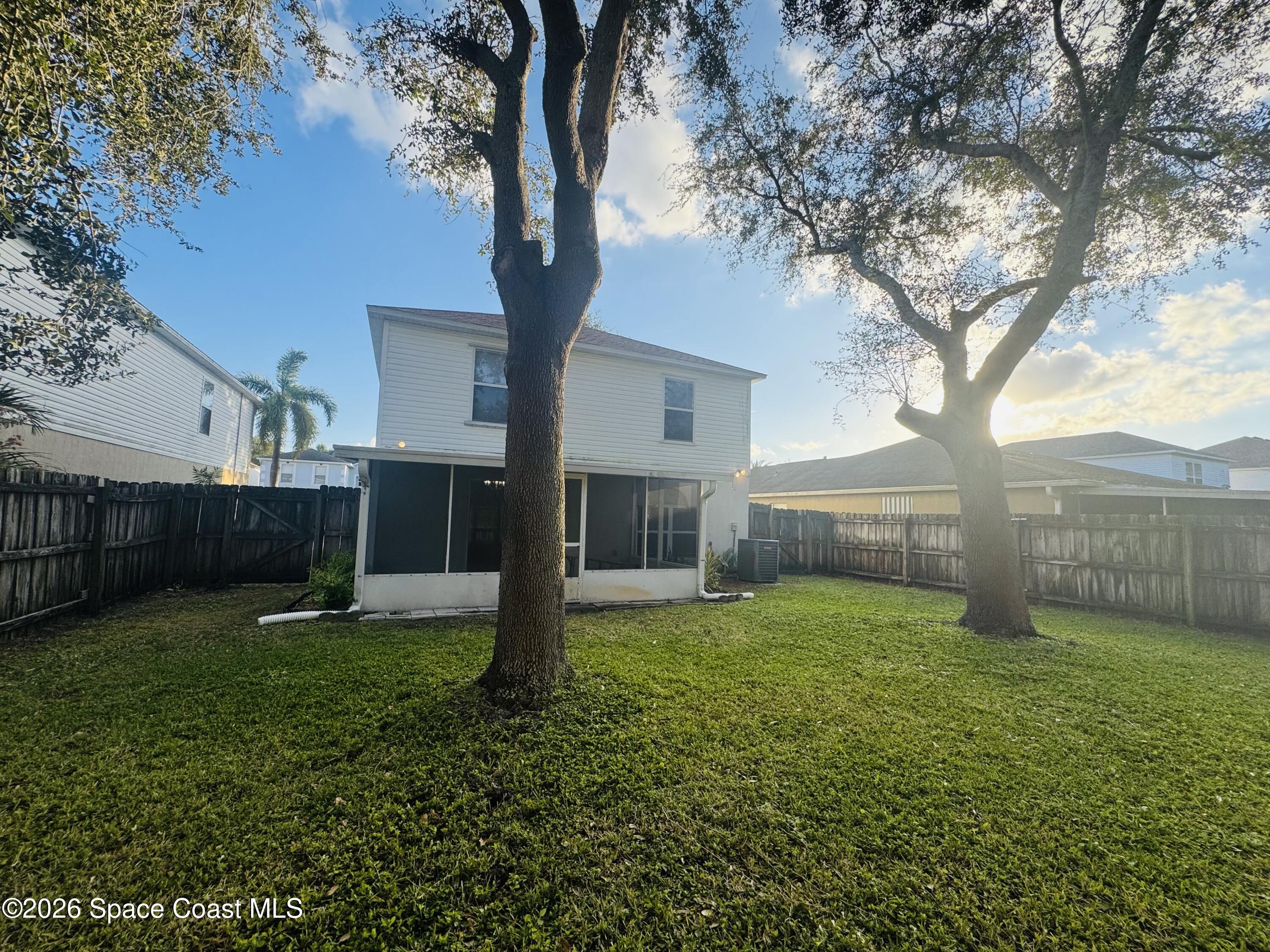4550 Elena Way Melbourne, FL 32934 - Photo 25 of 33 a view of a backyard with a tree