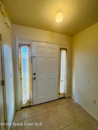a view of a room with an empty space and a window