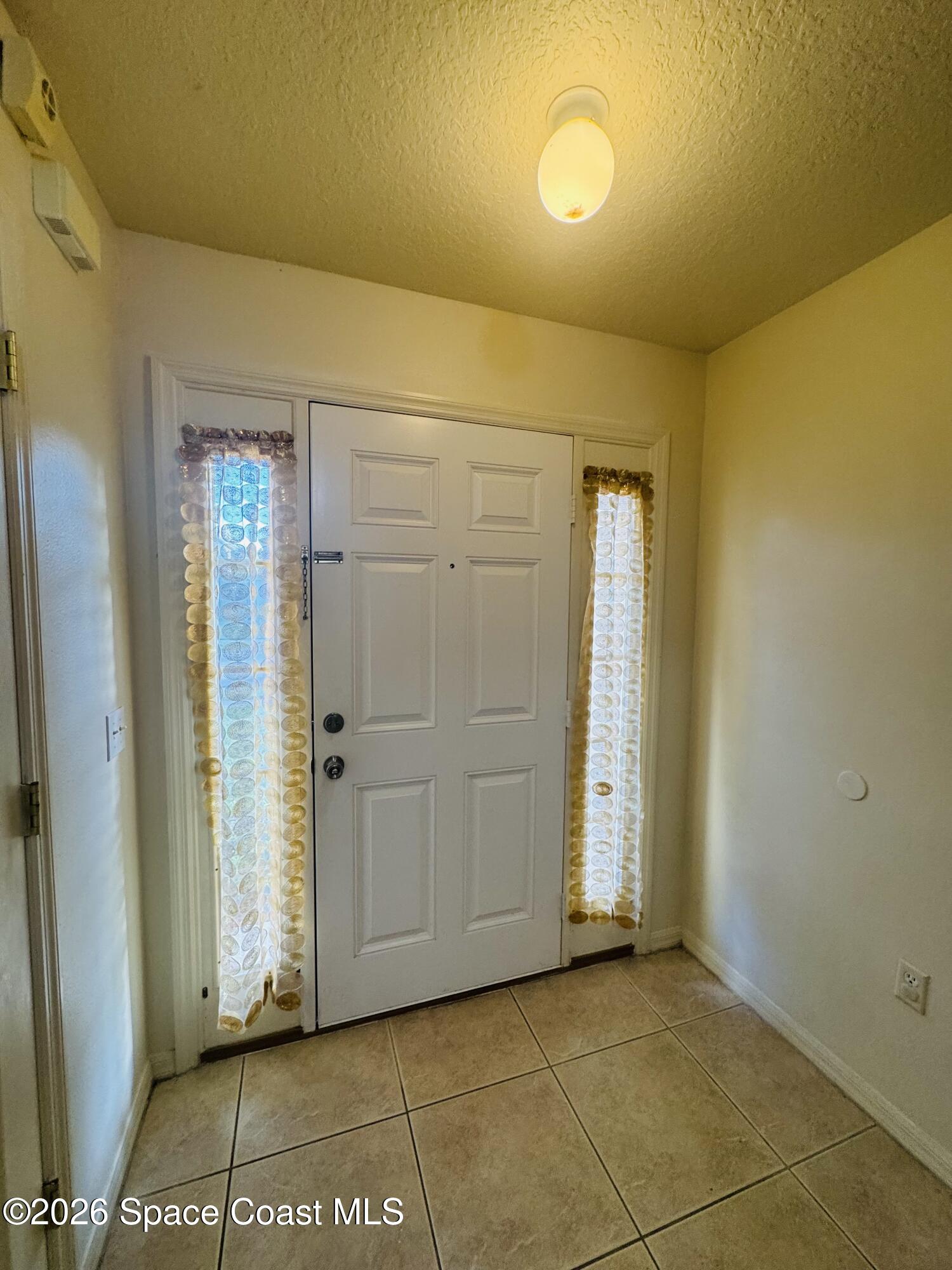 4550 Elena Way Melbourne, FL 32934 - Photo 3 of 33 a view of a room with an empty space and a window