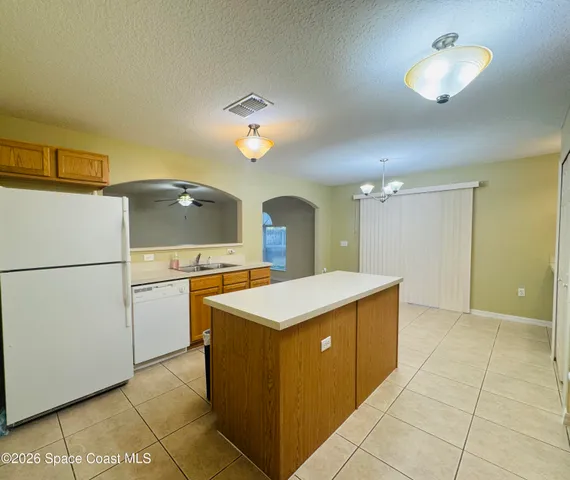 a kitchen with a cabinets and chandelier
