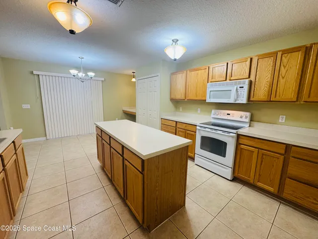 a kitchen with a stove sink and cabinets