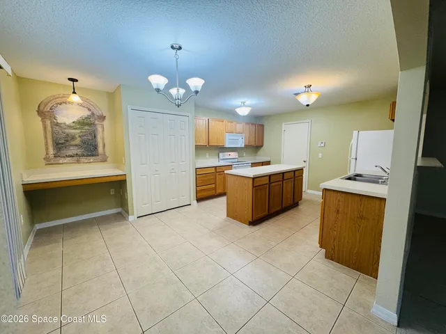 a kitchen with cabinets and window