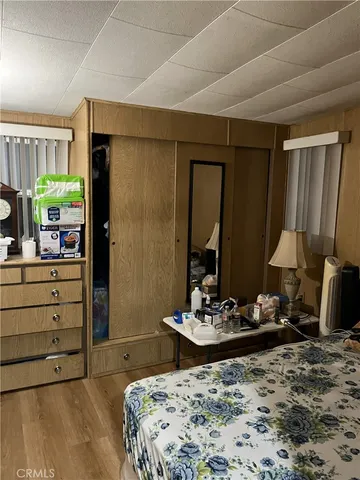 a bedroom with a bed and a mirror