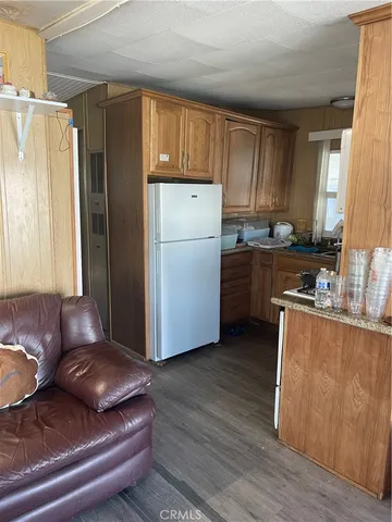 a kitchen with a refrigerator and a sink